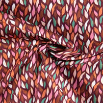 Tissu Popeline de Coton pétales multicolores sur fond Bordeaux