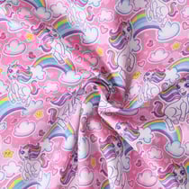 Tissu Coton imprimé Ella licornes et arc en ciel sur fond Rose bonbon - Au mètre