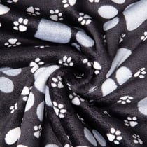Tissu Doudou imprimé empreintes pattes sur fond Noir