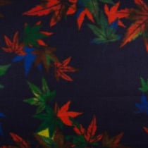 Tissu Caban Laine Feuilles orange et vertes sur fond Bleu marine
