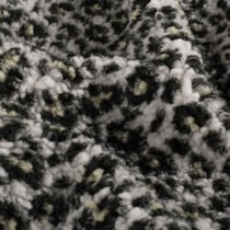 Tissu Fausse fourrure Mouton Yséa  léopard effet moucheté sur fond Blanc