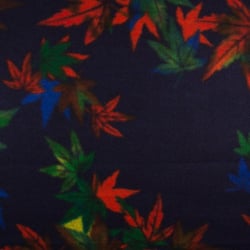 Tissu Caban Laine Feuilles orange et vertes sur fond Bleu marine