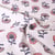 Tissu Toile de Coton Canvas Poppy Fleuris rose et parme sur fond Blanc