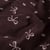 Tissu Velours milleraies Isaé noeuds Roses sur fond Prune foncé