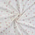 Tissu Jersey Coton Fleurs roses, taupes et or pailleté sur fond Blanc