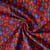 Tissu Coton imprimé Arty Gigi tapis fleuri Rouge et Violet sur fond Bordeaux