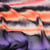 Tissu Mousseline rayé orange et violet sur fond Noir