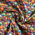 Tissu Coton imprimé Coquillage arc en ciel sur fond Violet
