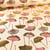 Tissu Toile Coton Feuilles de Gingko dorés et rose sur fond Naturel