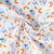 Tissu Coton imprimé Fuzy motifs fleuris bleus et orange sur fond Blanc - Par Coupon de 3m