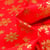 Tissu Coton imprimé Bio Flocons dorés sur fond Rouge
