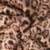 Tissu Fausse fourrure Léna motif panthère Noir sur fond Beige sable